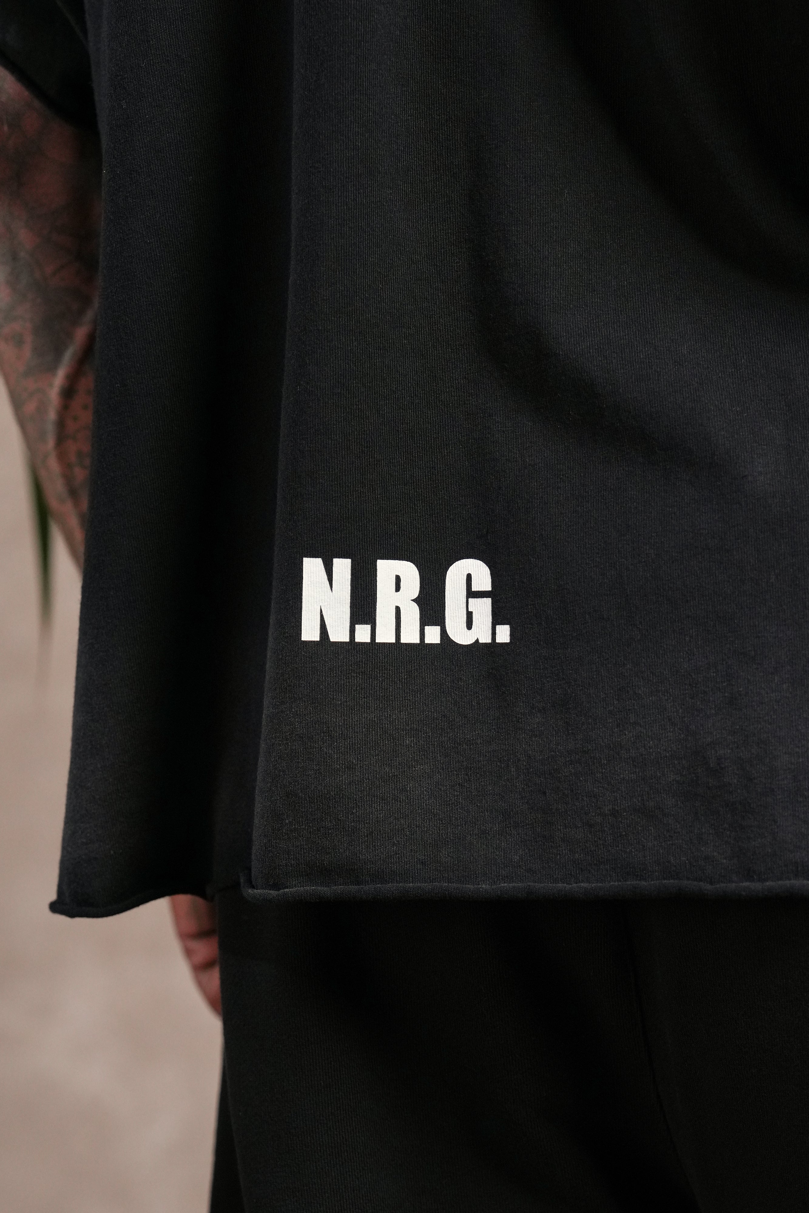 N.R.G. Grunge Cut-Off Mid Length Raw Hem Tee in Black Drift Wash