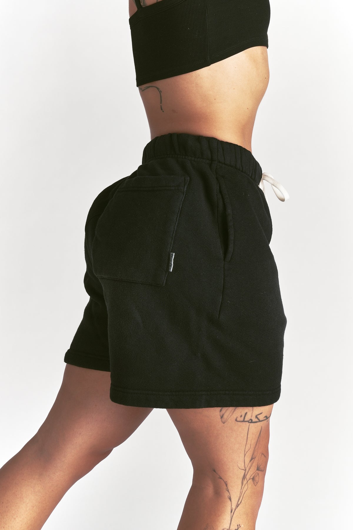 IYKYK Patched Oversized Sweat Short in Black Sun Fade