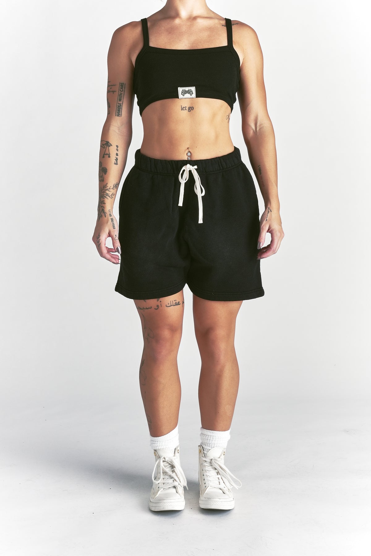 IYKYK Patched Oversized Sweat Short in Black Sun Fade