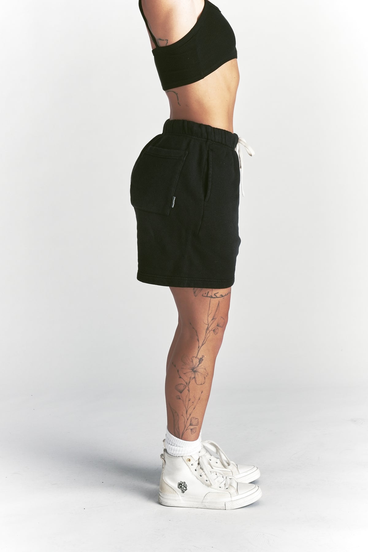 IYKYK Patched Oversized Sweat Short in Black Sun Fade
