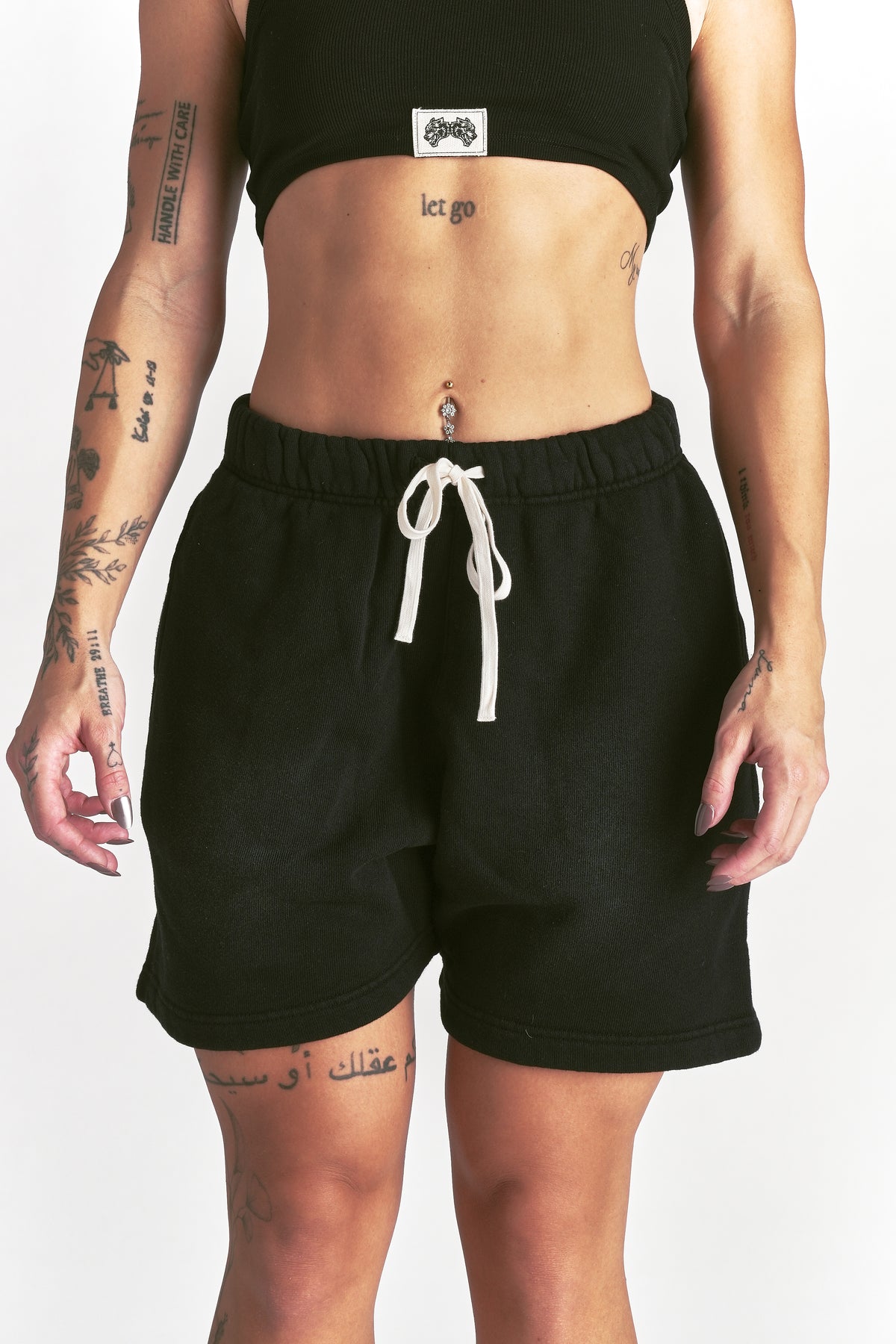 IYKYK Patched Oversized Sweat Short in Black Sun Fade
